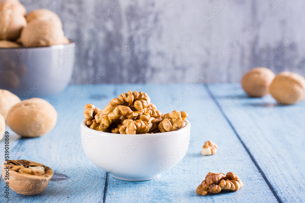 Peeled walnuts in a bowl on the table. Organic food. Peeled walnuts in a bowl on the table. Organic food.