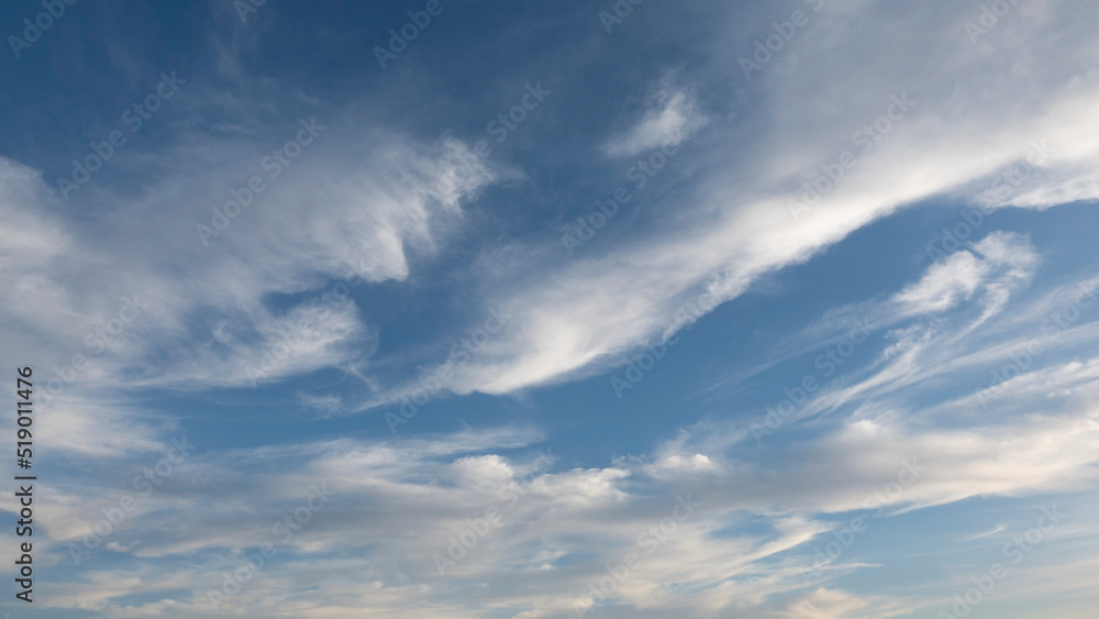 Beautiful wind shaped clouds and blue sky for background use or sky substitution