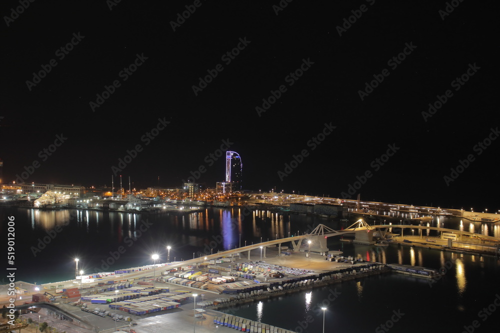 Night Panoramic view of barcelona and cargo port in spain
