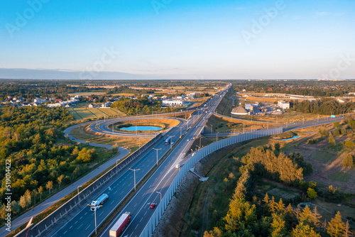 Aerial view of highway and roundabout at sunset in the evening