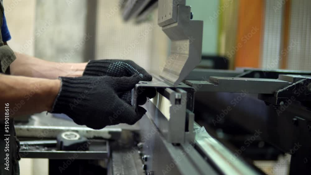 The employee hands are not bending the large parts of the metal on the ...