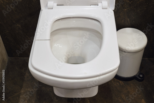 Cracked white toilet seat. A broken seat in the home toilet. © Андрей Журавлев