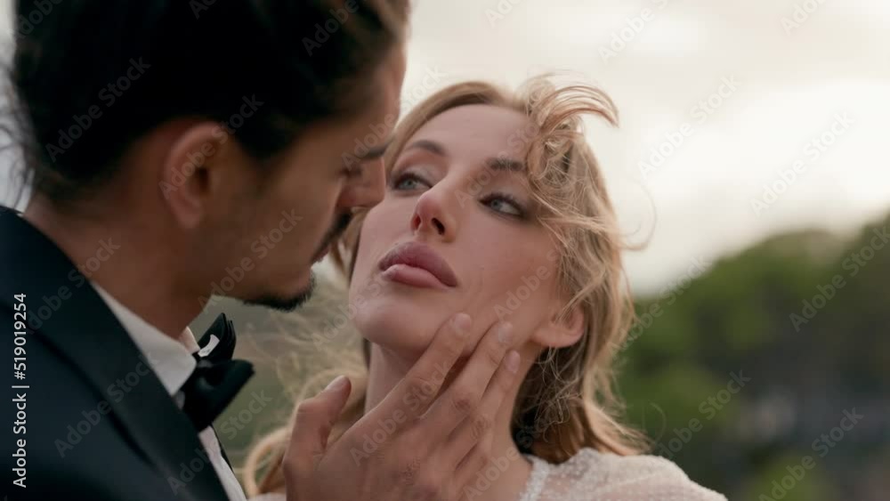 Tender Kiss Of Young Bride And Groom. Girl In White Dress And Man In Suit. Tender Kiss Of Young Bride And Groom. Girl In White Dress And Man In Suit.