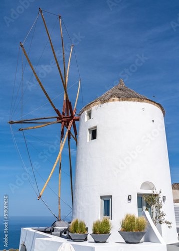 Iconic white windmill at Oia village  Santorini  Greece