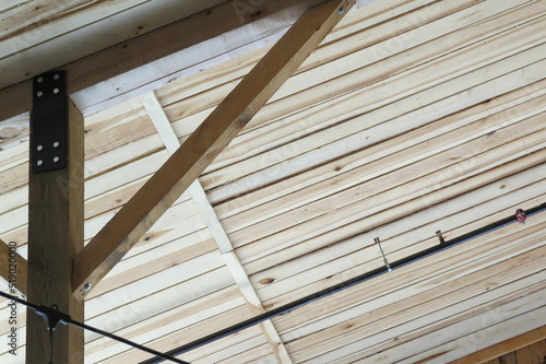 wood paneled ceiling of barn with timber frame