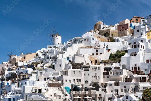 Scenic view of Oia with its typical windmill and white house. Oia is a top destination for honeymoon and romantica vacations, Santorini, Greece
