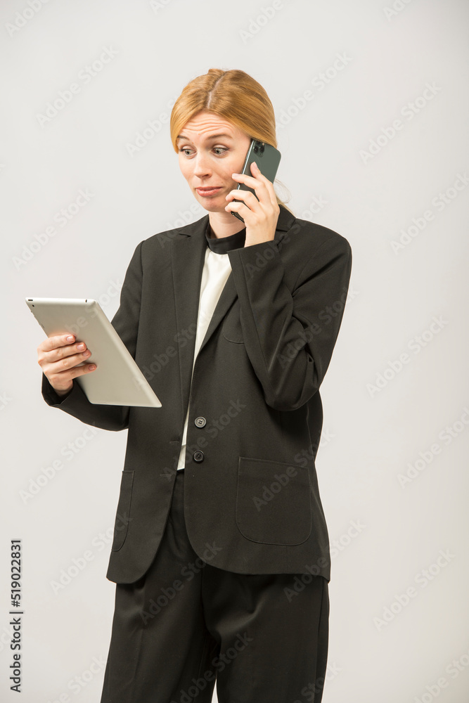 girl uses tablet and phone.portrait of young girl business lady with tablet and smartphone isolated.does online shopping business banking videoconference girl uses tablet and phone.portrait of young girl business lady with tablet and smartphone isolated.does online shopping business banking videoconference
