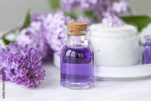 Concept of pure natural organic plant-based ingredients in cosmetology  herbal and flower extract. Lilac for anti-age and anti-acne therapy  gentle face and body skin care
