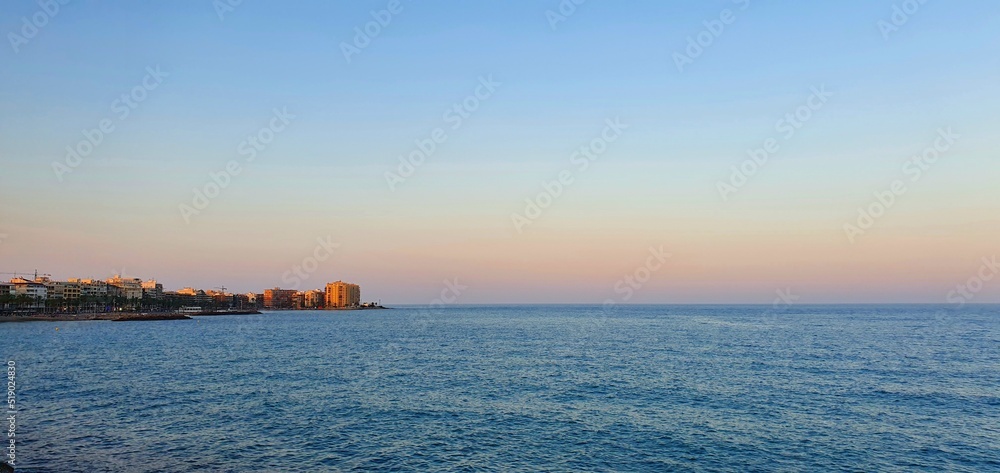 Gentle beautiful sunset on the sea in Spain. Vanilla sunset in Spain. Sea and sunset in Torrevieja. Calm on the sea. Beautiful calm and sunset. Rest on the sea.
