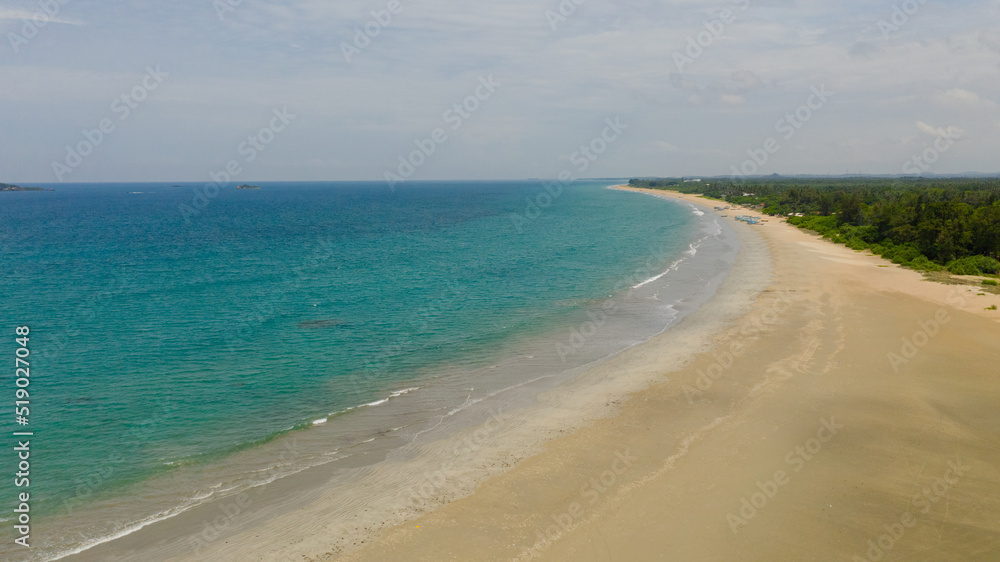 A tropical beach with palm trees and a blue ocean. Sri Lanka. A tropical beach with palm trees and a blue ocean. Sri Lanka.