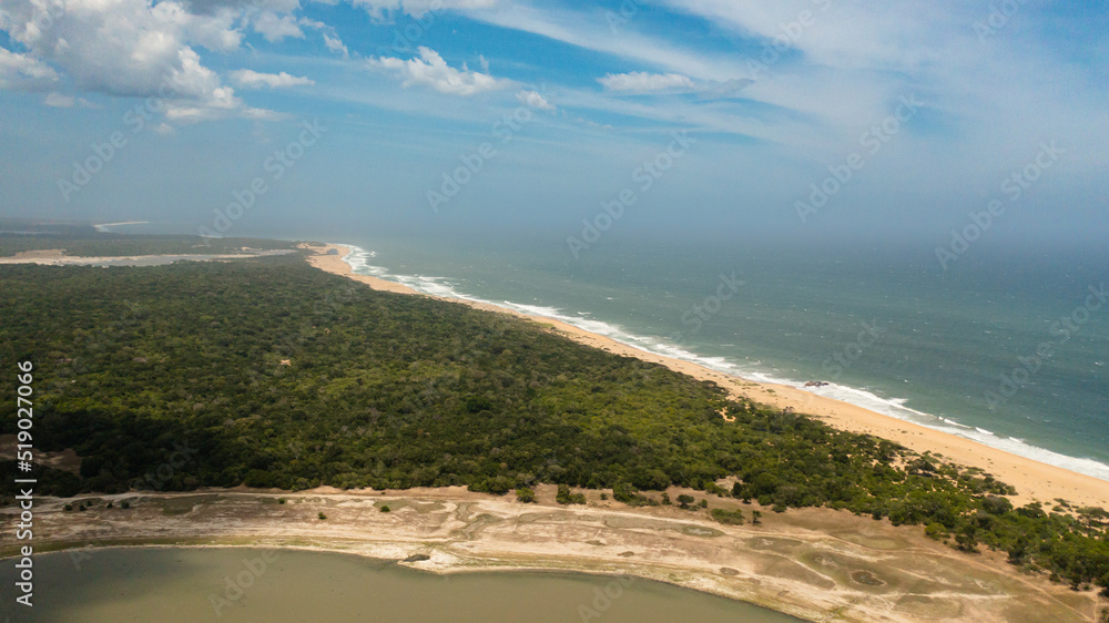 Wild beach in the national park surrounded by rainforest and jungle.