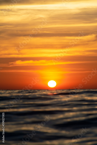 Fototapeta Naklejka Na Ścianę i Meble -  beautiful sea sunset with bright yellow sun. View very close to the water