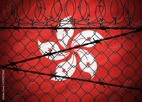 Hong Kong flag behind barbed wire and metal fence