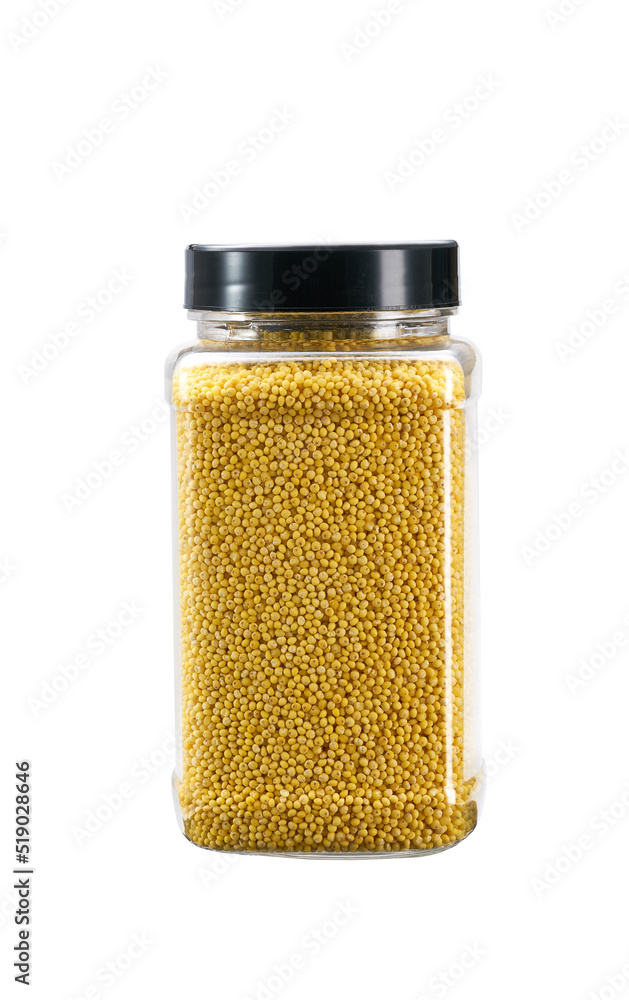 plastic jar with uncooked millet yellow grains isolated on white background. plastic jar with uncooked millet yellow grains isolated on white background.