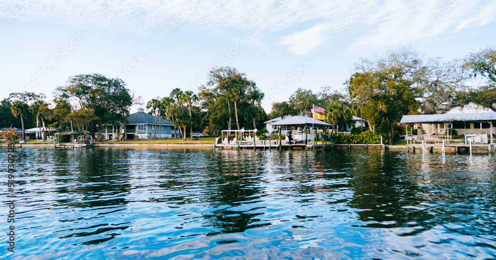 Fototapeta premium Riverview, Florida, USA - 02 10 2022: River view house and dock along Little Manatee River