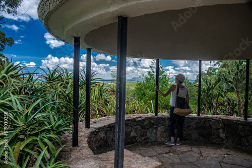 Mature woman standing looking at the landscape towards Piriápolis at the Lussich Arboretum viewpoint in the department of Maldonado, Uruguay. photo