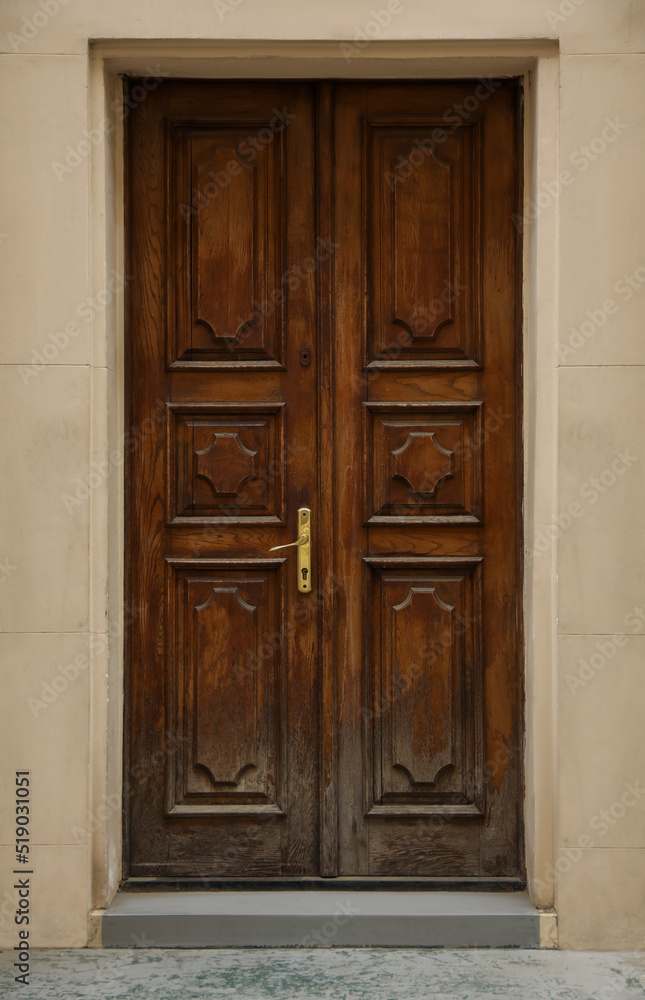 View of building with wooden door. Exterior design View of building with wooden door. Exterior design