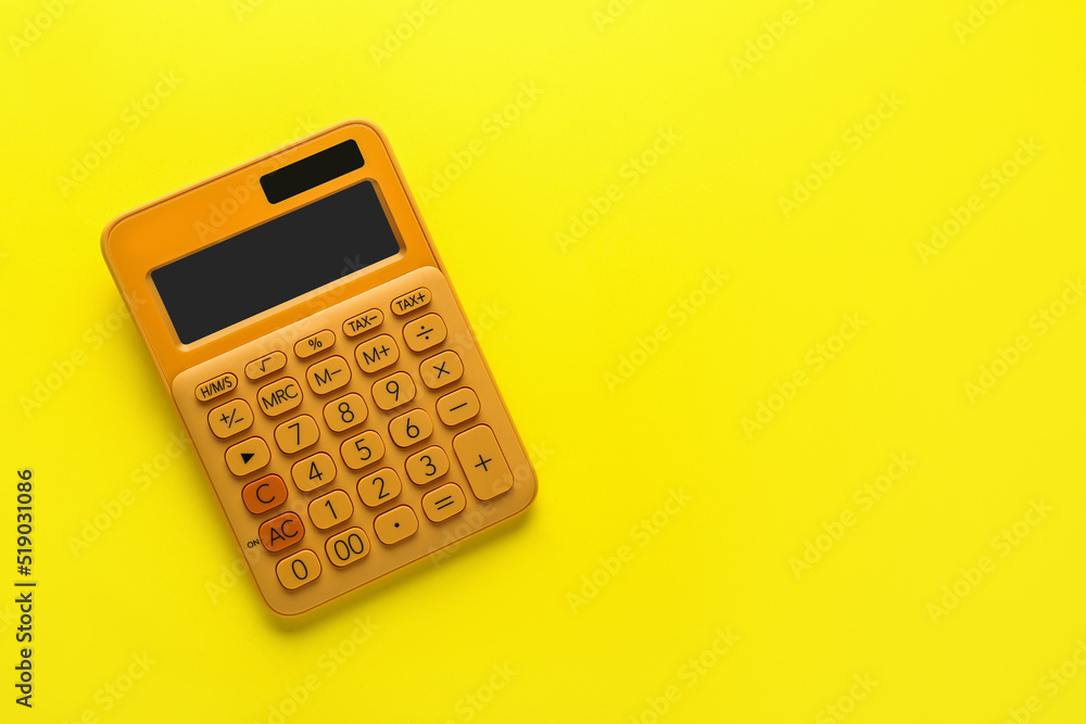 Orange calculator on yellow background, top view. Space for text Orange calculator on yellow background, top view. Space for text