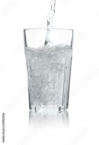 Pouring soda water into glass on white background