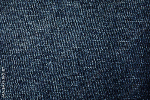 Texture of dark blue jeans as background, closeup