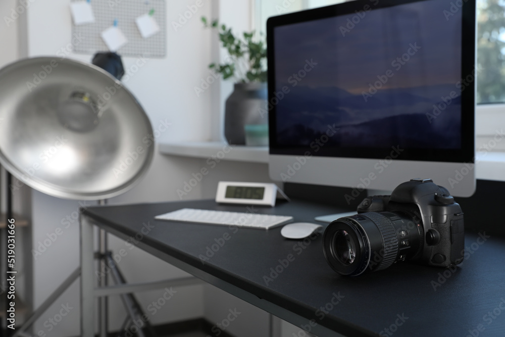 Professional camera and computer on table in photo studio. Interior design Professional camera and computer on table in photo studio. Interior design