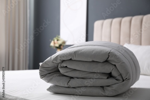 Soft folded blanket on bed at home photo