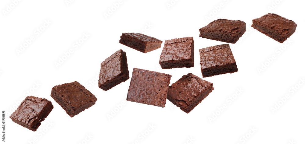 Slices of delicious chocolate brownie flying on white background. Banner design Slices of delicious chocolate brownie flying on white background. Banner design