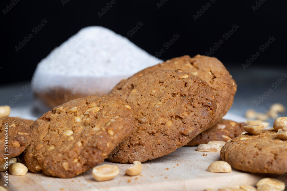 Fototapeta premium oatmeal cookies with peanuts on a black wooden table
