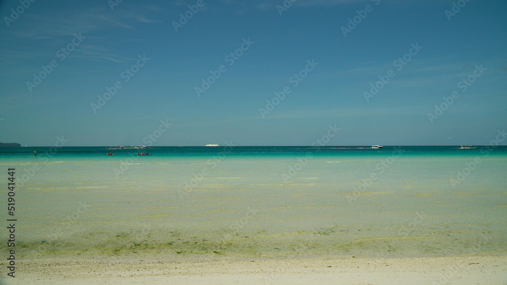 Seascape: blue sea and tropical beach on a background of blue sky. Summer and travel vacation concept. Boracay, Philippines Seascape: blue sea and tropical beach on a background of blue sky. Summer and travel vacation concept. Boracay, Philippines