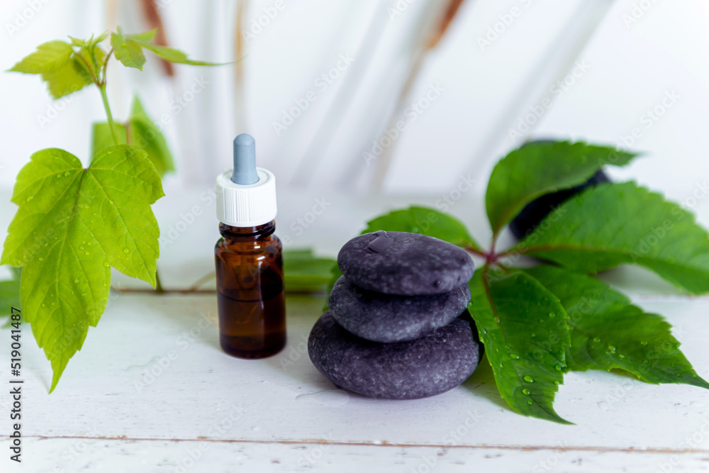 Still life meditation, stones on top of each other with a bottle of liquid Still life meditation, stones on top of each other with a bottle of liquid