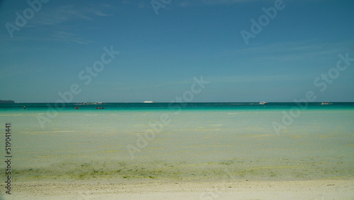 Seascape: blue sea and tropical beach on a background of blue sky. Summer and travel vacation concept. Boracay, Philippines
