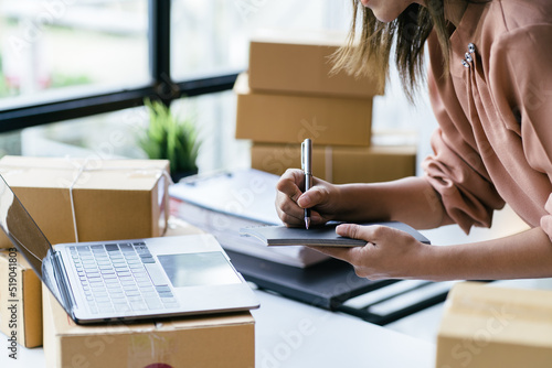 Starting small businesses SME owners female entrepreneurs check online orders to prepare to pack the boxes, sell to customers, sme business ideas online. © PaeGAG