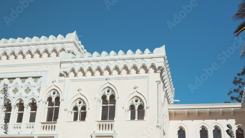 Palm Tree In Front Of Palacio Vergara Museum In Venetian Neo-Gothic Style. Quinta Vergara Park In Vina del Mar, Valparaiso, Chile. pan left, reveal photo