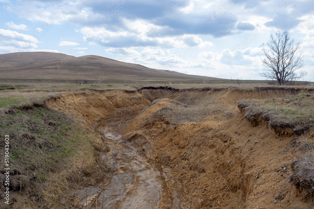 Deep clay ravine. Water erosion of the soil. Natural landscape. Deep clay ravine. Water erosion of the soil. Natural landscape.