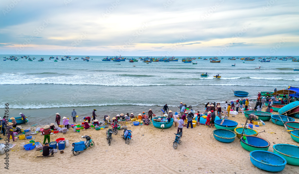 Mui Ne fish market seen from above, the morning market in a coastal fishing village to buy and sell seafood for the central provinces of Vietnam Mui Ne fish market seen from above, the morning market in a coastal fishing village to buy and sell seafood for the central provinces of Vietnam