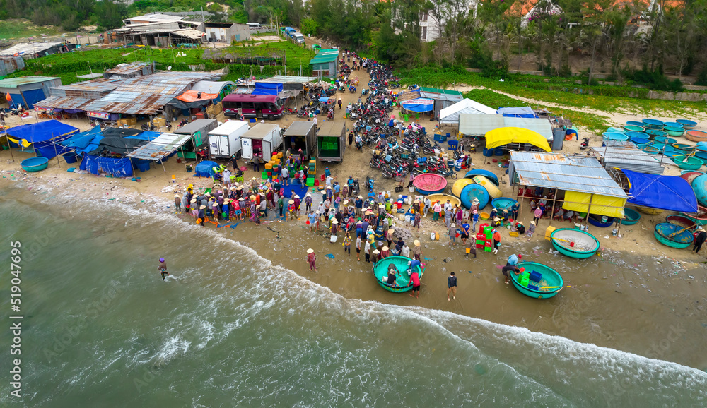 Mui Ne fish market seen from above, the morning market in a coastal fishing village to buy and sell seafood for the central provinces of Vietnam