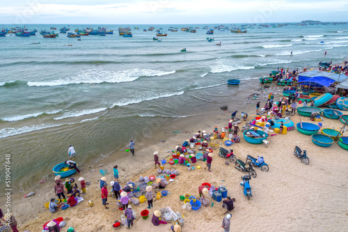 Mui Ne fish market seen from above, the morning market in a coastal fishing village to buy and sell seafood for the central provinces of Vietnam © huythoai