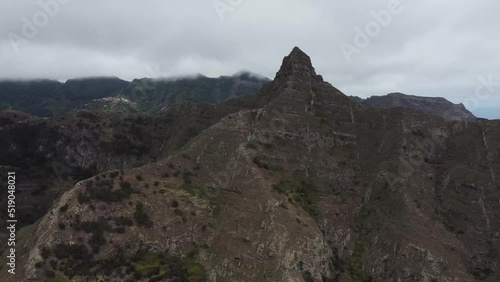 Dramatic Basaltic Rock Formation Of Roque De Taborno In Anaga Peninsula Of Tenerife, Spain. Aerial-Forward Shot photo