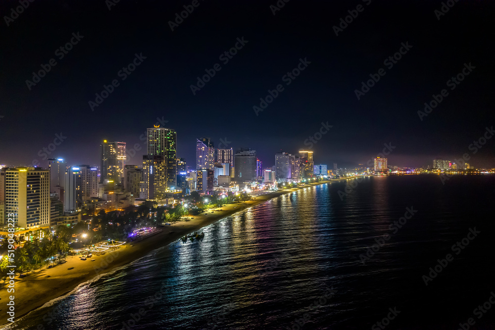 Fototapeta premium The coastal city of Nha Trang seen from above at night. This is a famous city for cultural tourism in central Vietnam