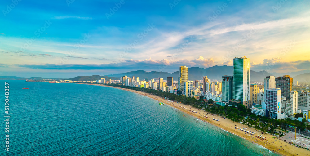 Fototapeta premium The coastal city of Nha Trang, Vietnam seen from above in the afternoon with its beautiful city and clean sandy beach attracts tourists to visit