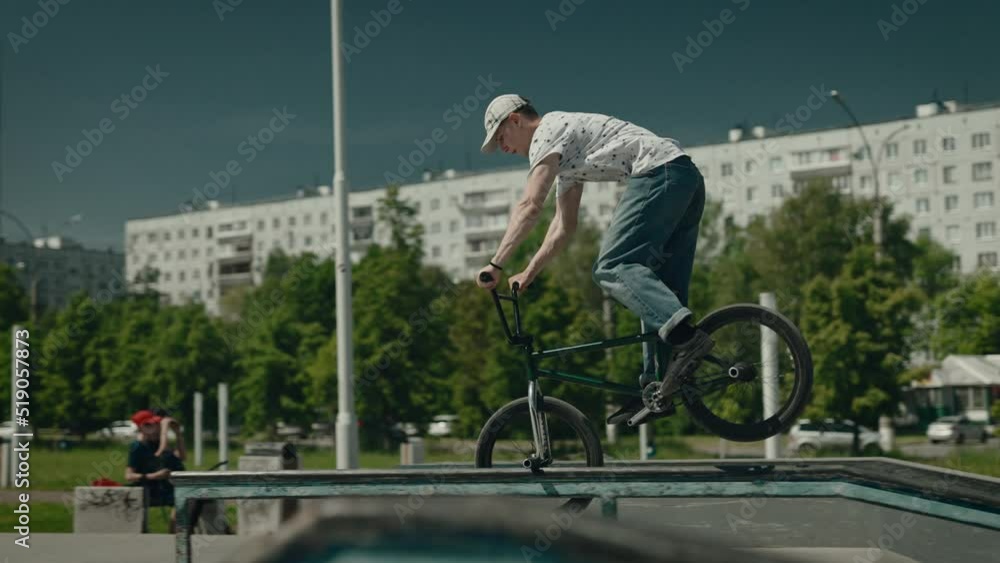 Urban extreme in the skatepark. A young man on a bicycle performs tricks and jumps. Extreme Urban extreme in the skatepark. A young man on a bicycle performs tricks and jumps. Extreme
