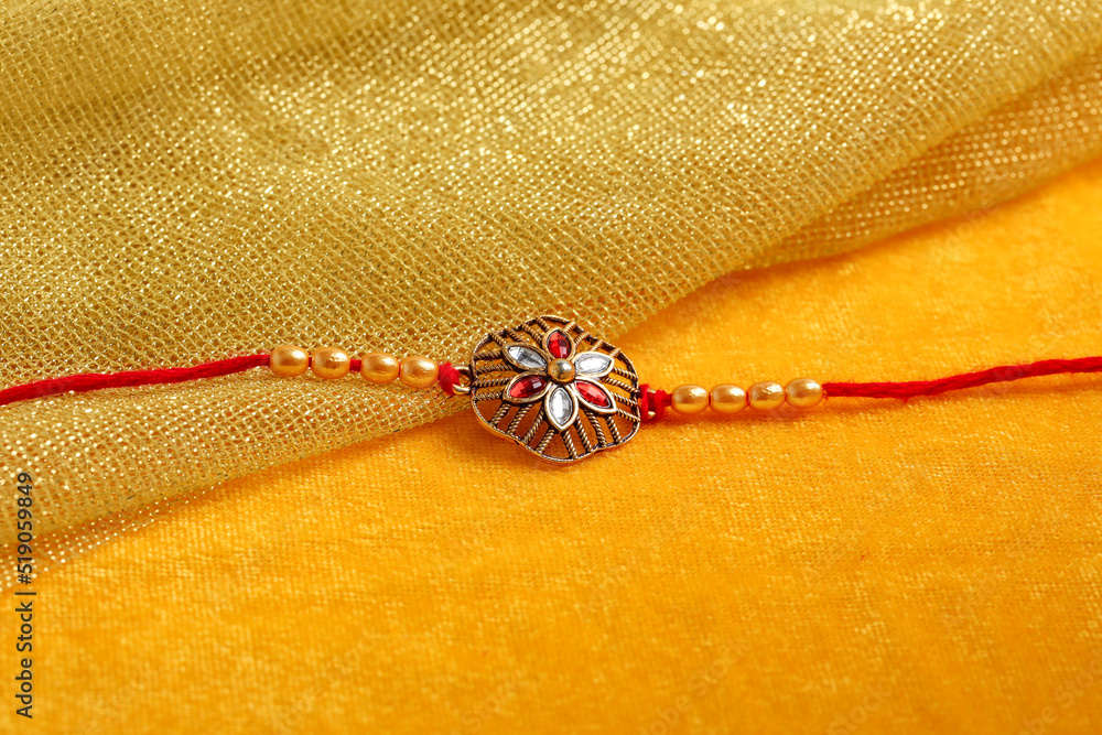 Indian festival: Raksha Bandhan. A traditional Indian wrist band which is a symbol of love between Brothers and Sisters. Indian festival: Raksha Bandhan. A traditional Indian wrist band which is a symbol of love between Brothers and Sisters.