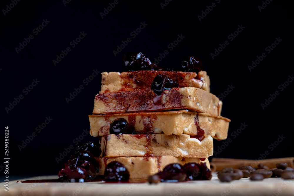 soft waffles with red cherry jam on a serving board soft waffles with red cherry jam on a serving board