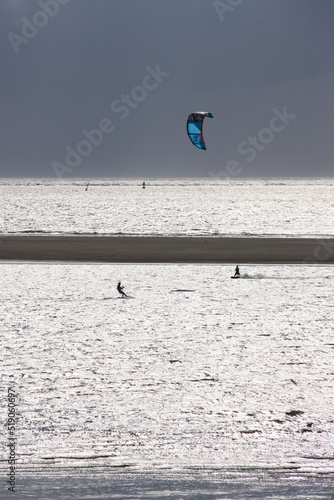 A kitesurfer rides across the north sea in strong winds © Marcus