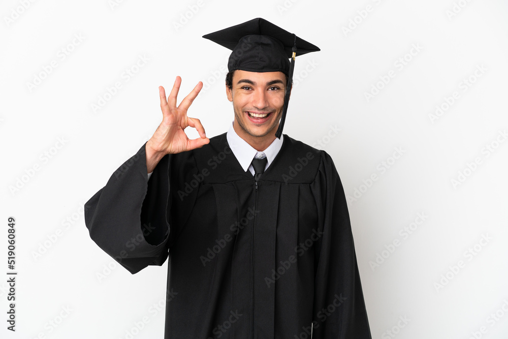Young university graduate over isolated white background showing ok sign with fingers Young university graduate over isolated white background showing ok sign with fingers