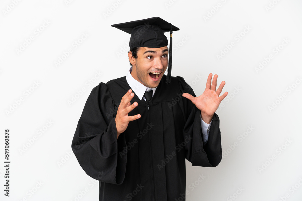Young university graduate over isolated white background with surprise facial expression Young university graduate over isolated white background with surprise facial expression