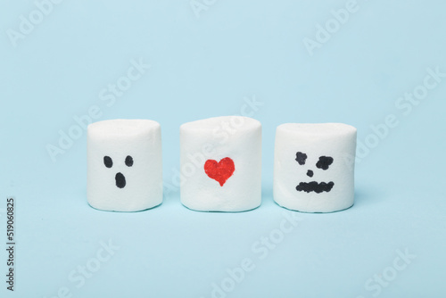 Marshmallow with red heart in toilet miniature on blue background