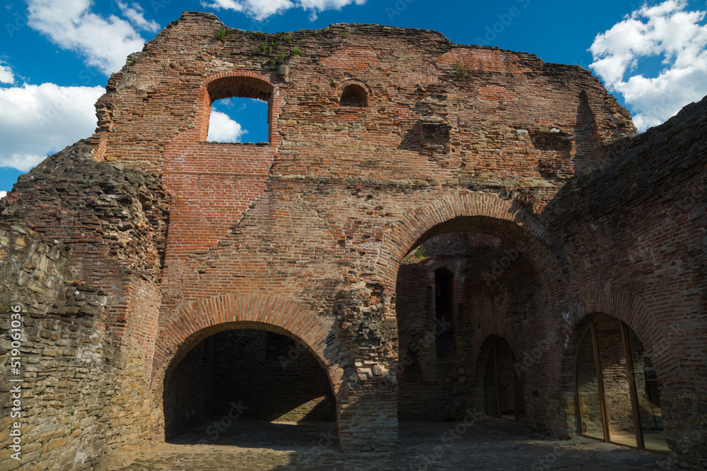 The Beautiful Ruins of an Old Romanian Fortification Covered by the Cloudy Summer Sky