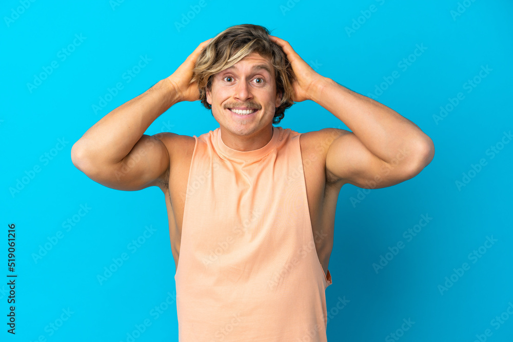 Handsome blonde man isolated on blue background doing nervous gesture Handsome blonde man isolated on blue background doing nervous gesture