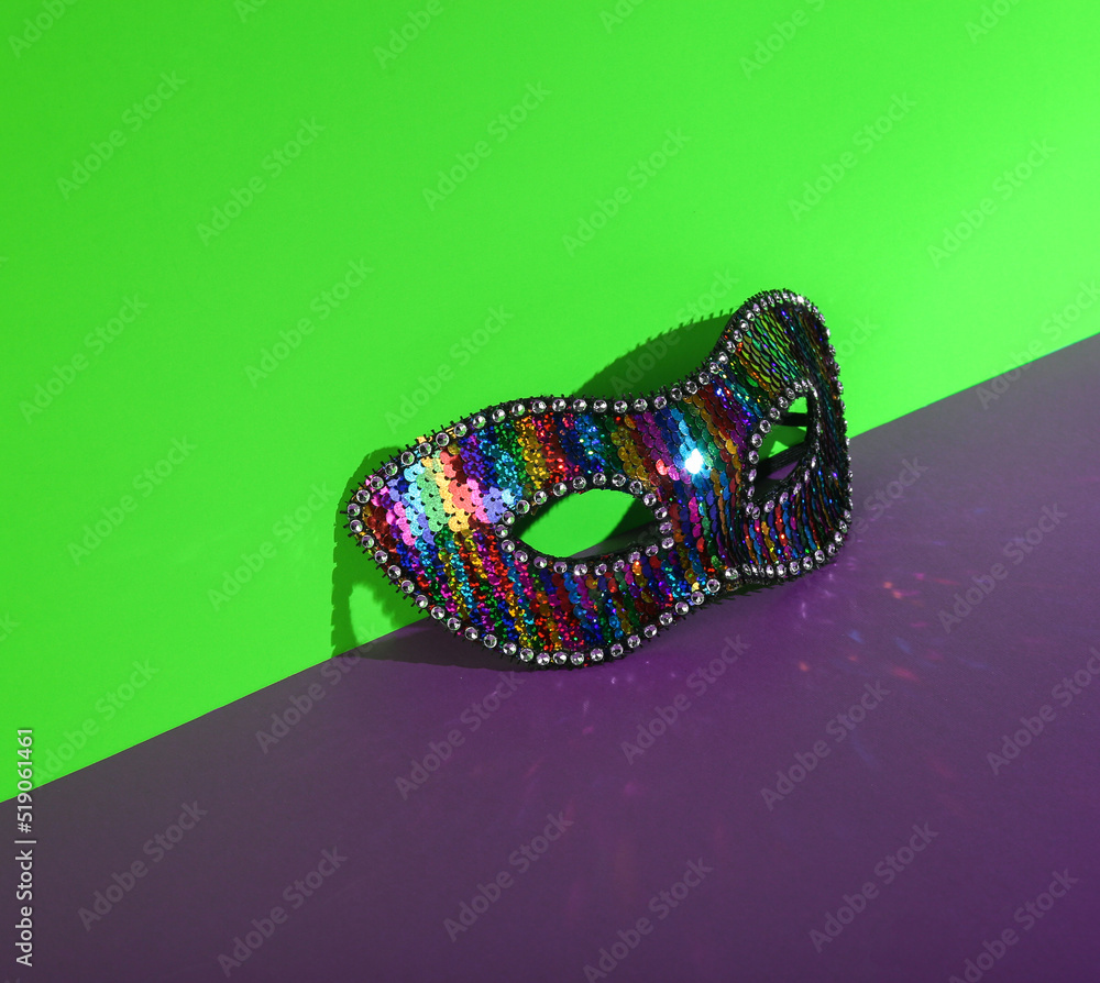 Fototapeta premium Carnival mask on green-purple background. Creative layout.